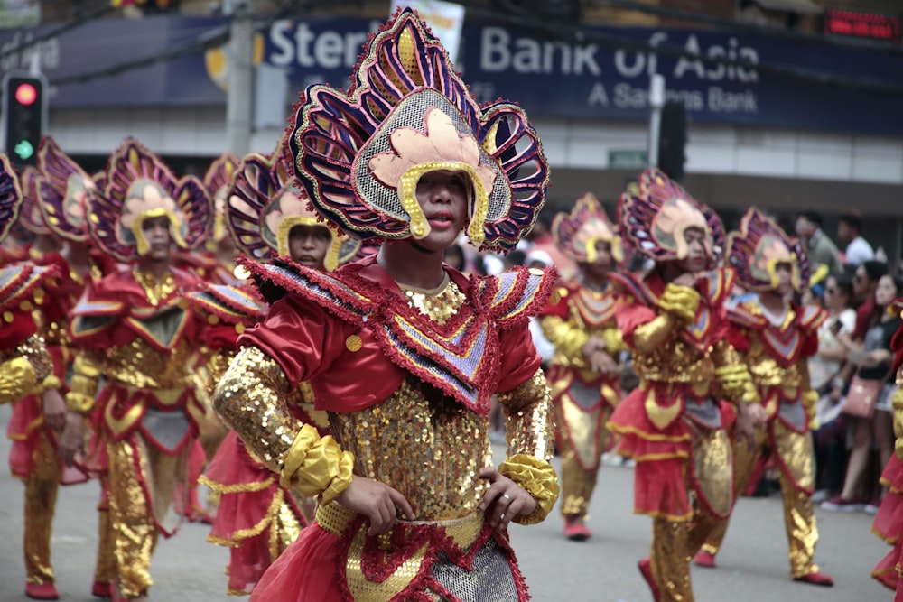 people in red and gold traditional dress