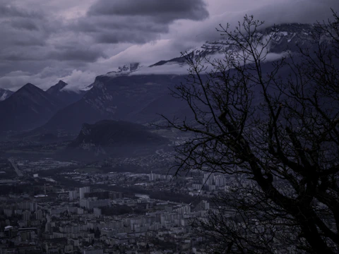 A dark, atmospheric map showing the five core cities connected by winding roads and marked with symbolic glyphs.