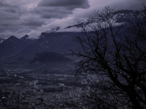 A moody, cinematic landscape of a futuristic city at dusk, blending 2D and 3D elements with realistic lighting.