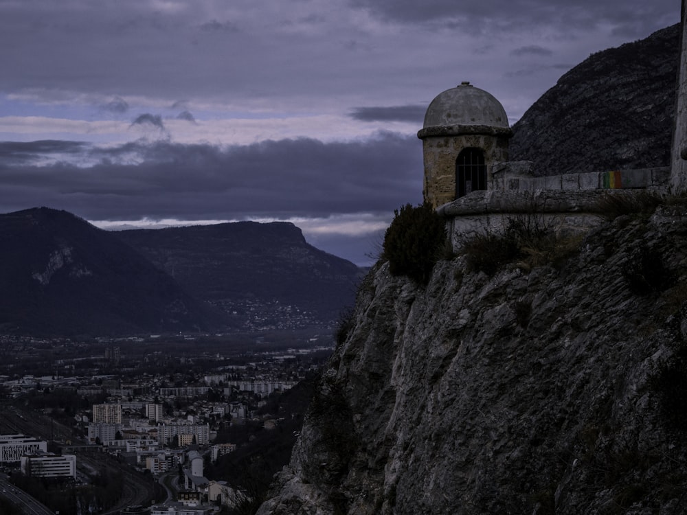 brown concrete building on top of mountain during daytime