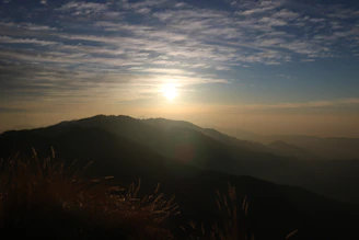 Wide shot of a large canvas featuring a serene mountain landscape at dawn.
