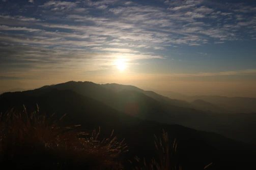 Wide shot of a large canvas featuring a serene mountain landscape at dawn.