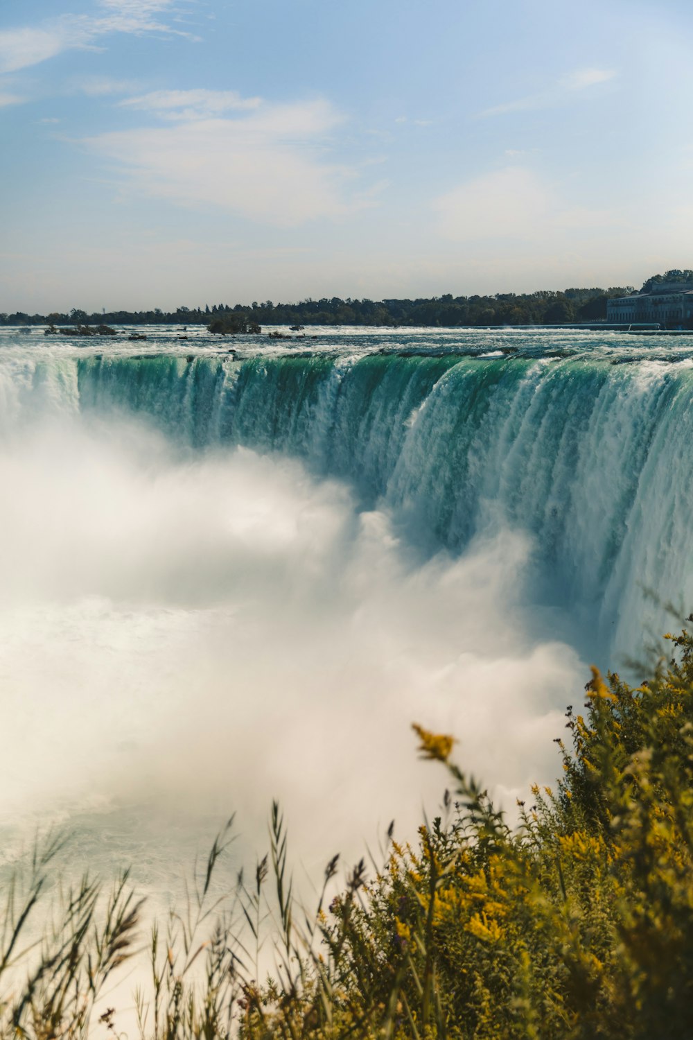 waterfalls under white cloudy sky during daytime