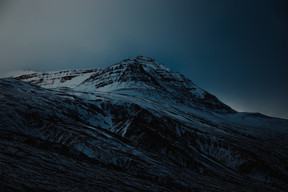 snow covered mountain under blue sky