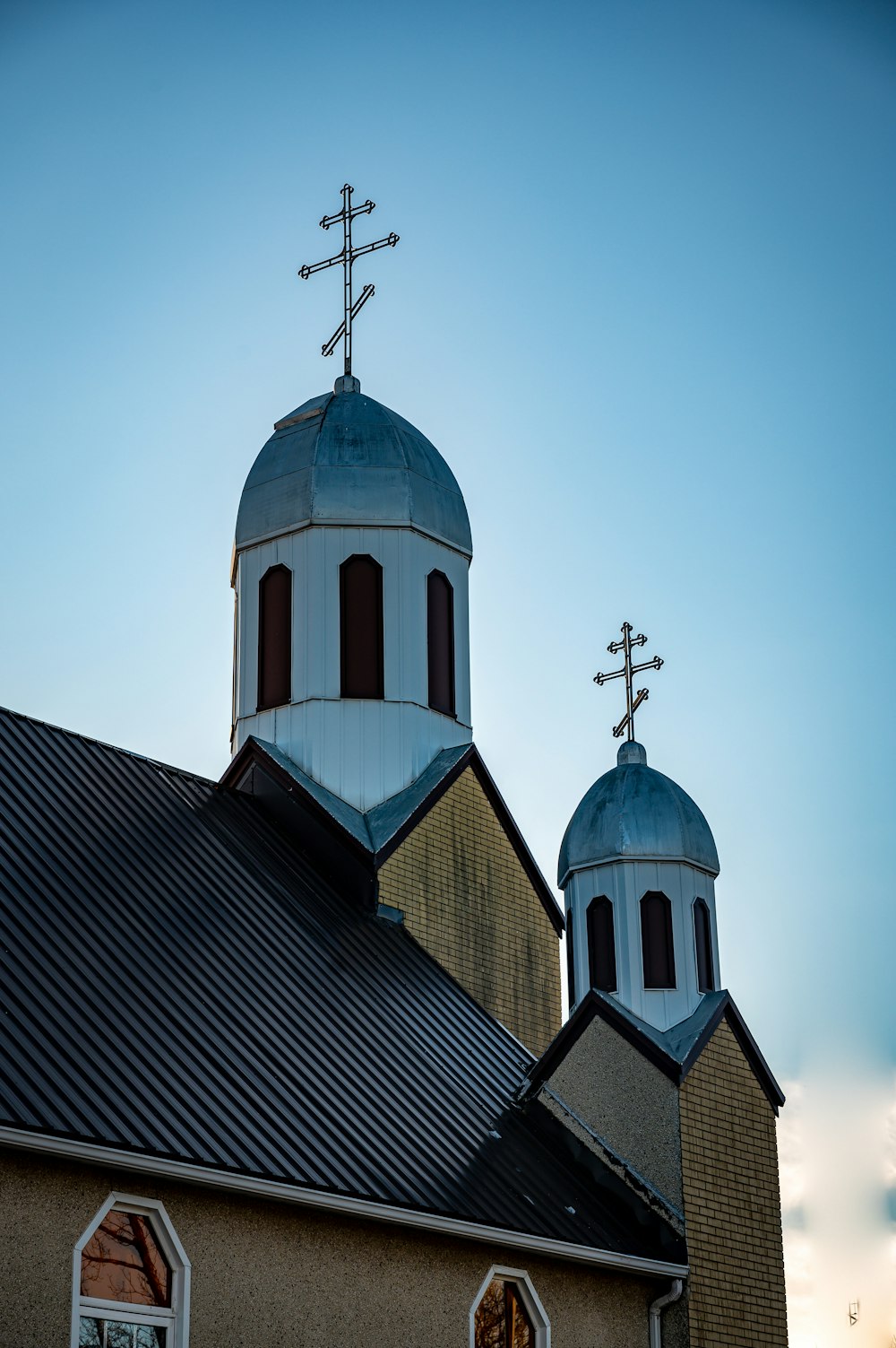 Iglesia marrón y blanca bajo el cielo azul durante el día