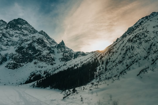 snow covered mountain under cloudy sky during daytime in Morskie Oko Poland