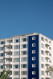 white and blue concrete building under blue sky during daytime