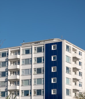 white and blue concrete building under blue sky during daytime