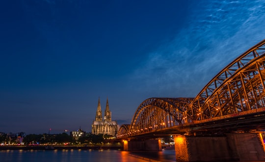 bridge over body of water during night time in Cologne Cathedral Germany