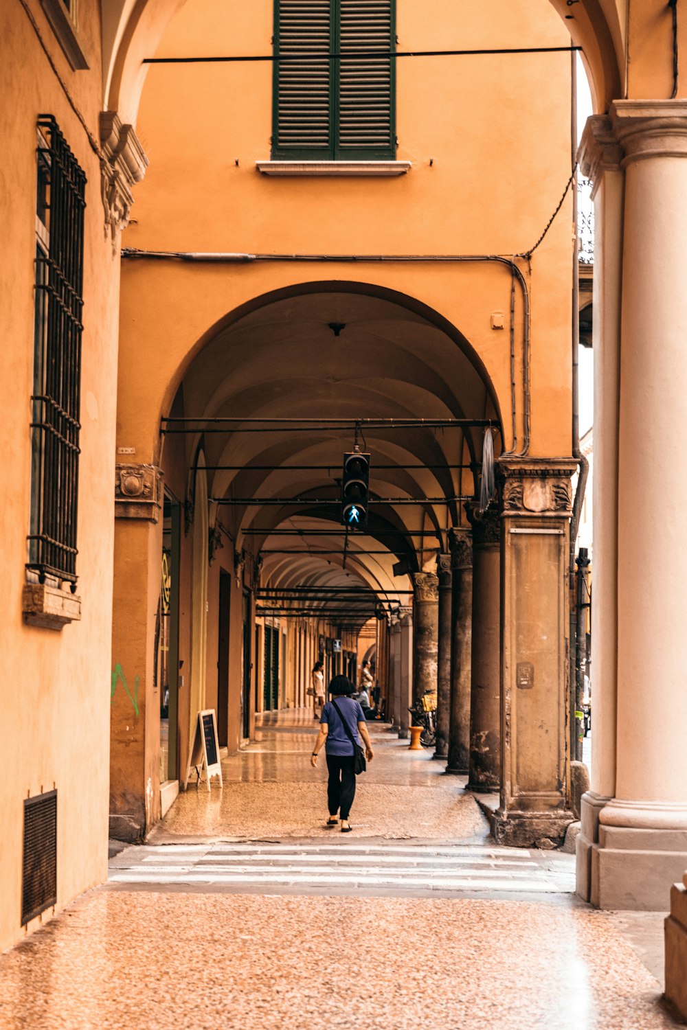 man in black jacket walking on sidewalk during daytime