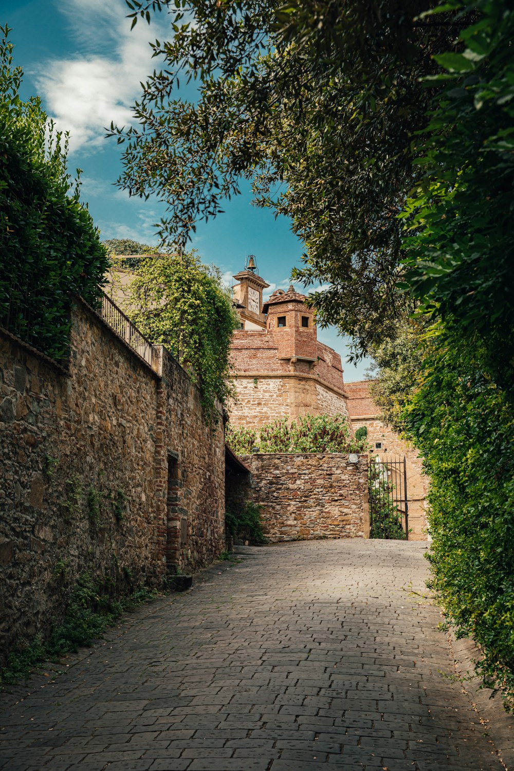 brown brick building near green trees during daytime