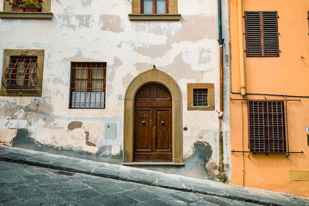 brown wooden door on white concrete building