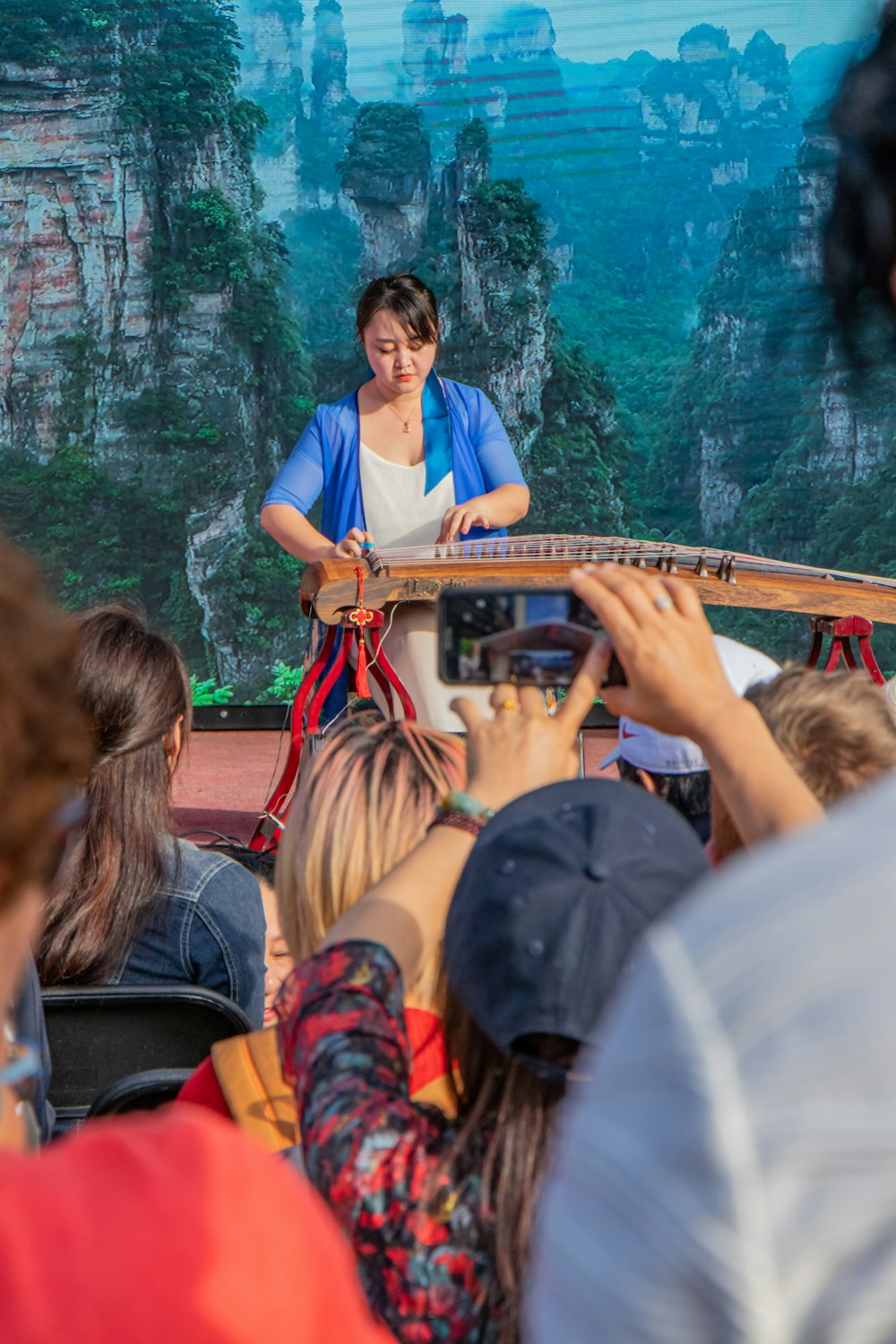 people sitting on red wooden bridge during daytime