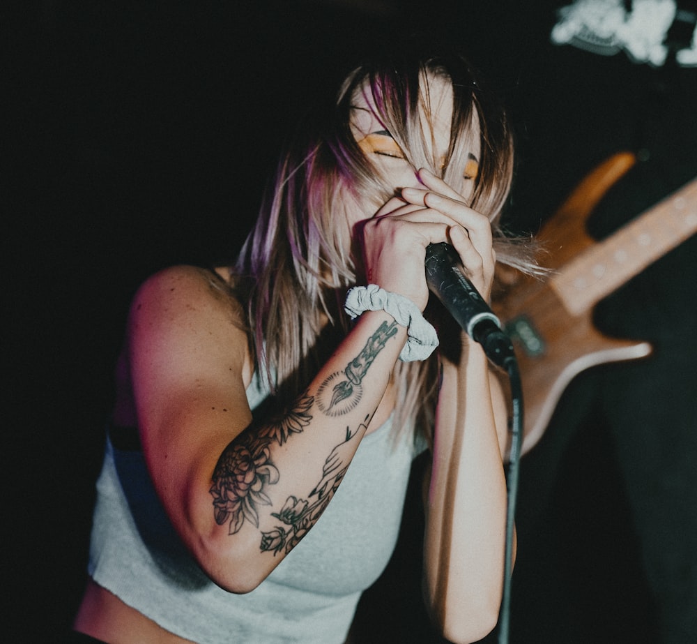 woman in gray tank top singing