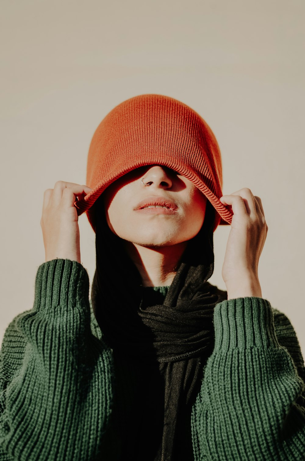 woman in red knit cap and black scarf