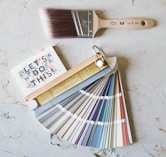 brown wooden handled brush on white surface