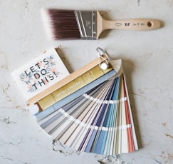 brown wooden handled brush on white surface