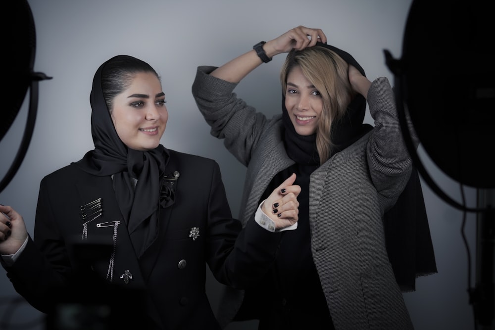 woman in black coat beside woman in gray sweater