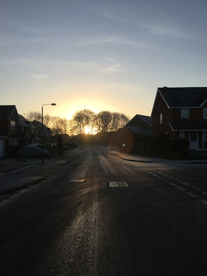 A vibrant sunrise over a quiet suburban neighborhood, symbolizing new beginnings.