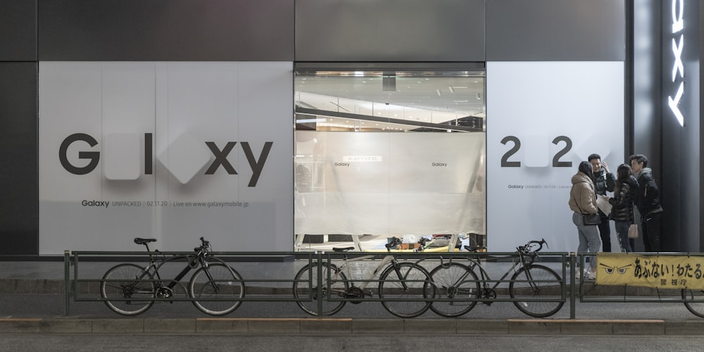 black city bike parked beside white wall