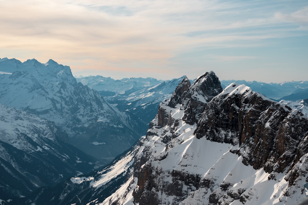 snow covered mountain under cloudy sky during daytime