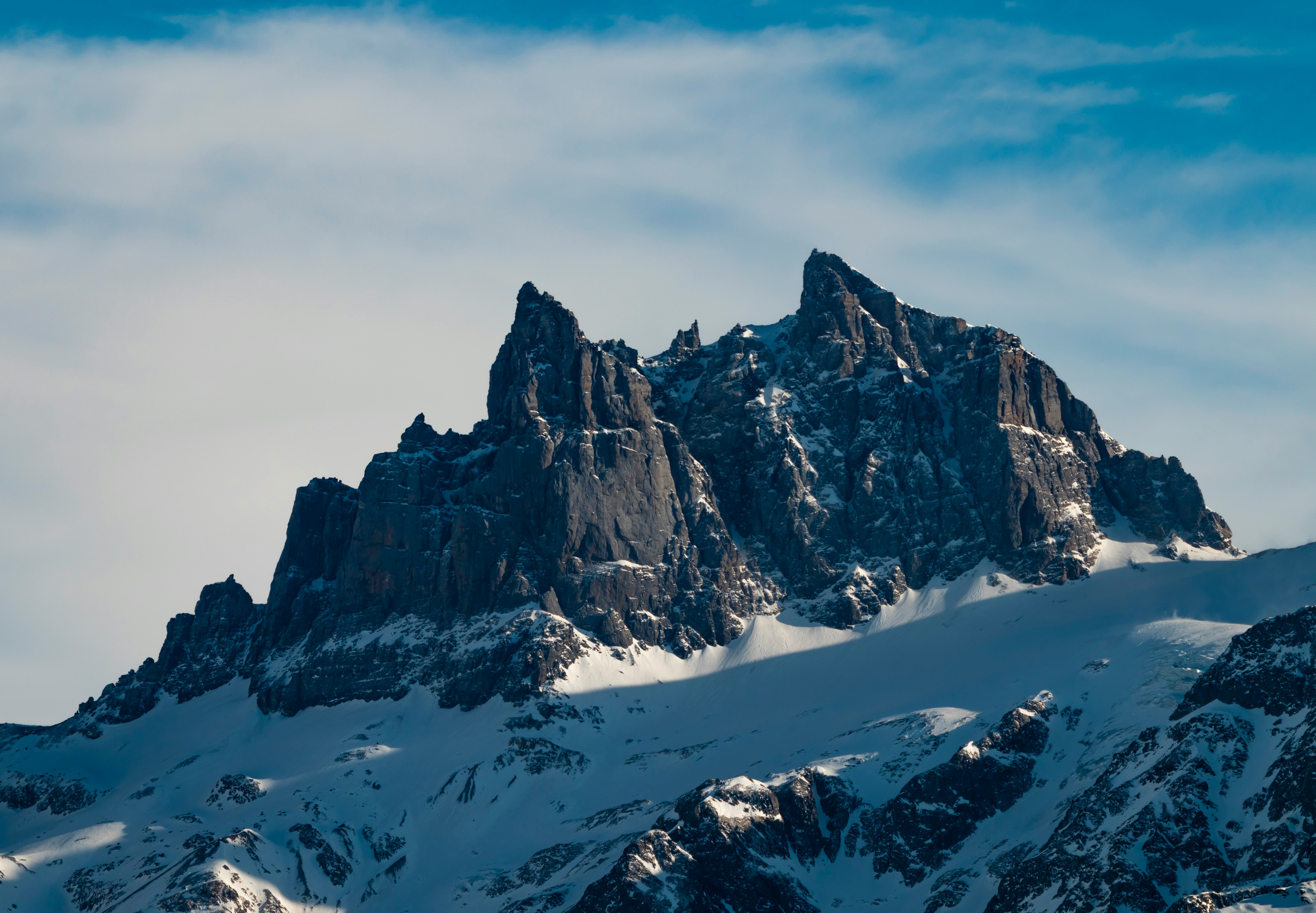 snow covered mountain under cloudy sky during daytime