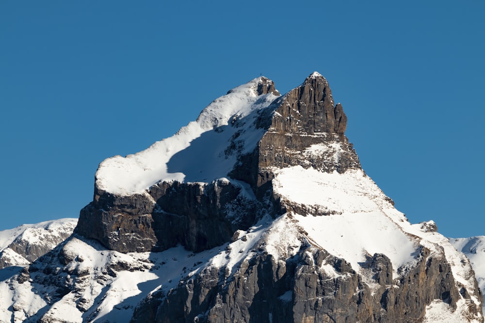 snow covered mountain under blue sky during daytime