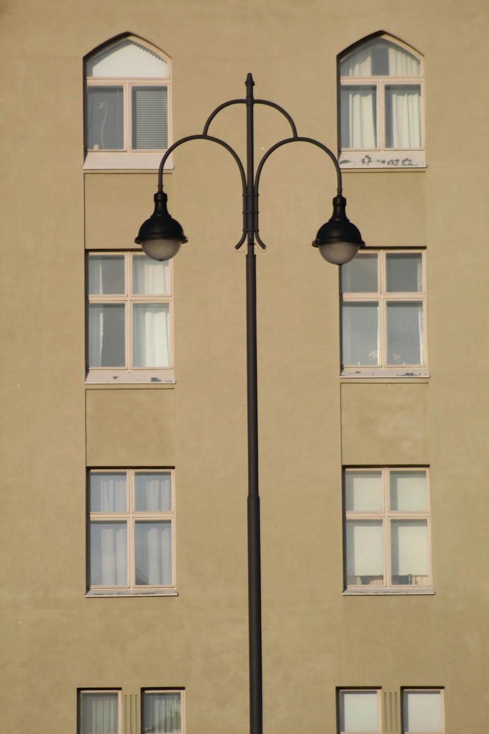 a street light in front of a tall building