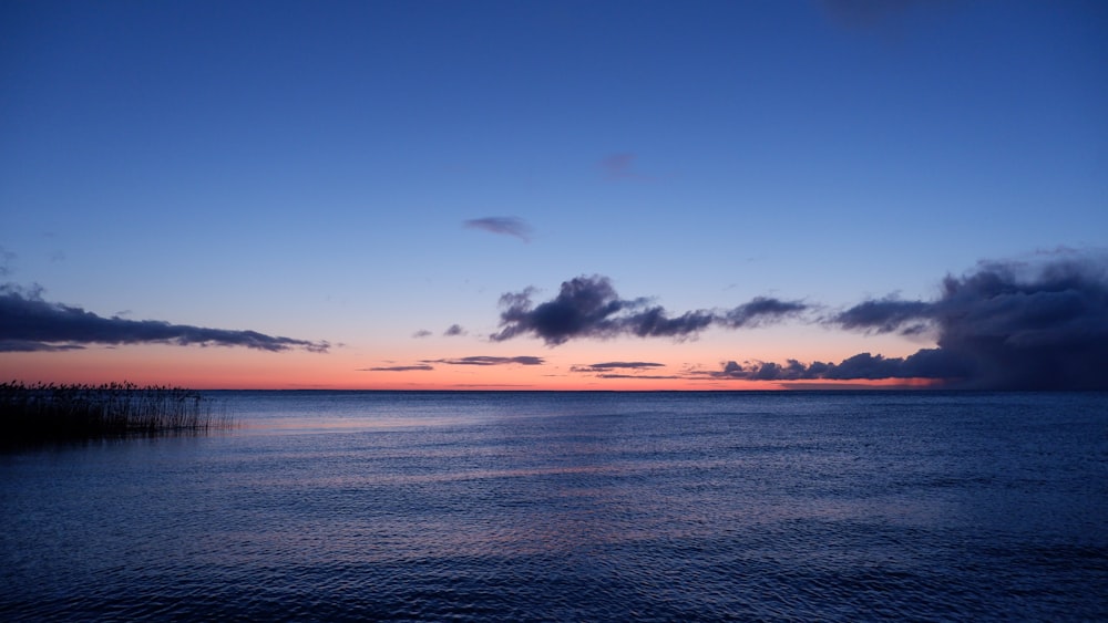 body of water under blue sky during daytime