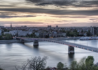 bridge over river during sunset