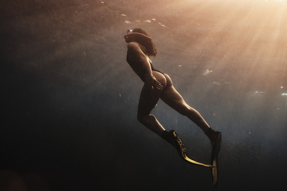 man in black shorts under water
