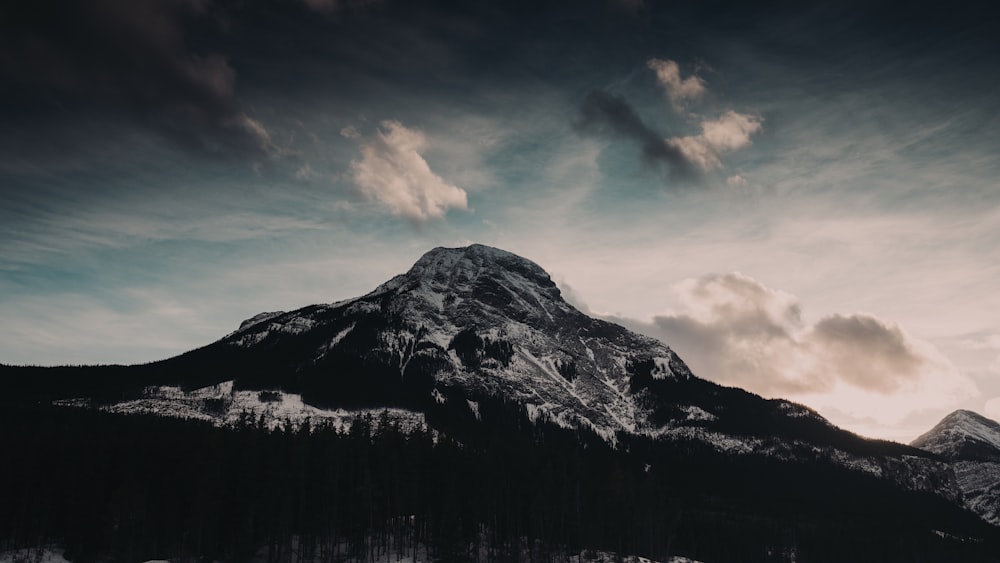 black and white mountain under cloudy sky during daytime