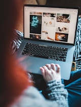 Entrepreneur working on laptop with coffee, smiling confidently.
