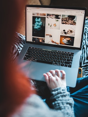 A person shopping online with a laptop and coffee.