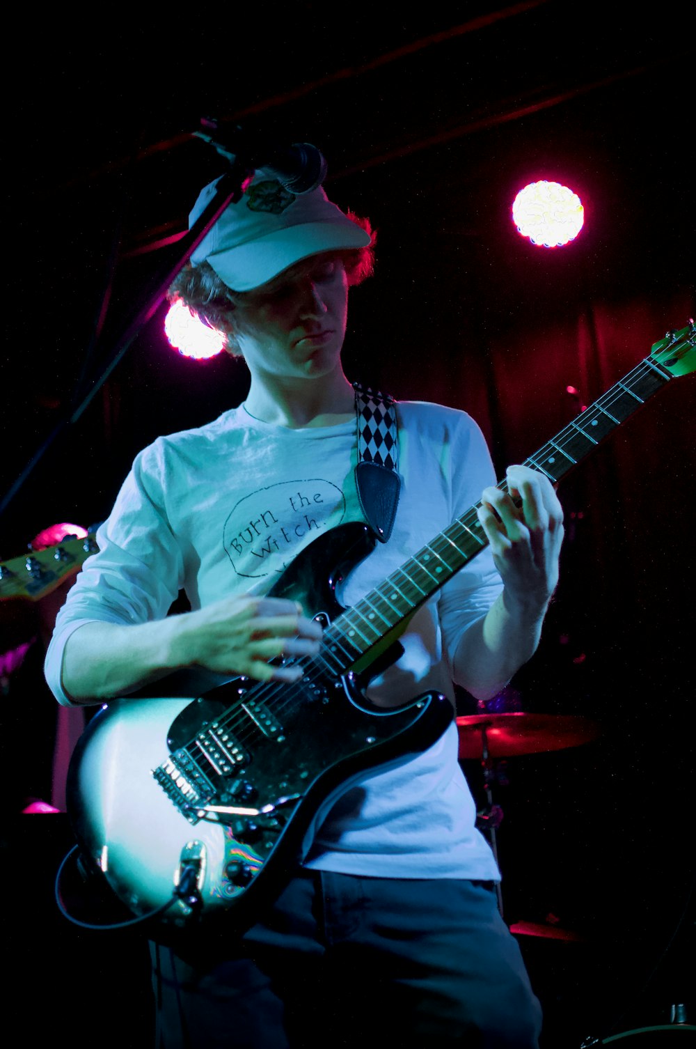 man in white and black crew neck t-shirt playing electric guitar