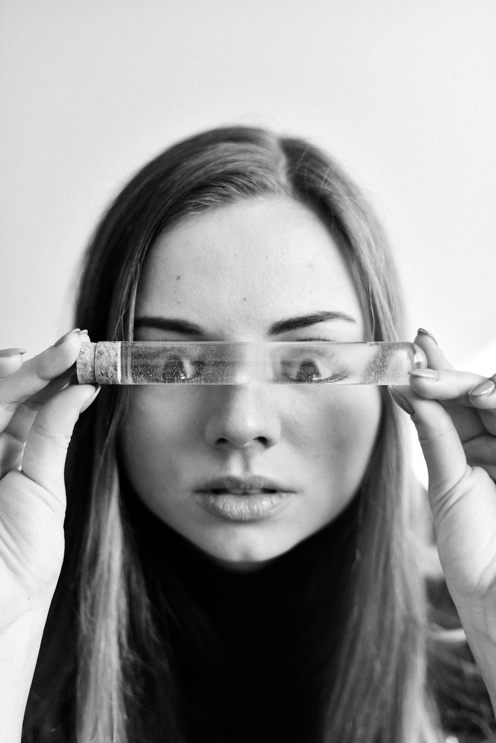 woman holding clear glass with white background