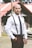 man in white dress shirt and black pants standing near red umbrella during daytime