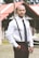 man in white dress shirt and black pants standing near red umbrella during daytime