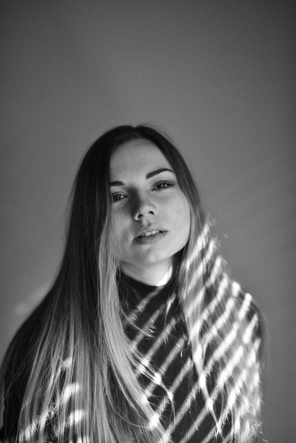 woman in white and black striped turtle neck shirt