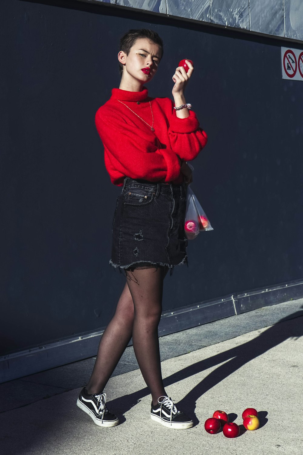 woman in red long sleeve shirt and black skirt
