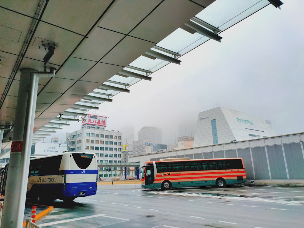 red and blue bus on road during daytime