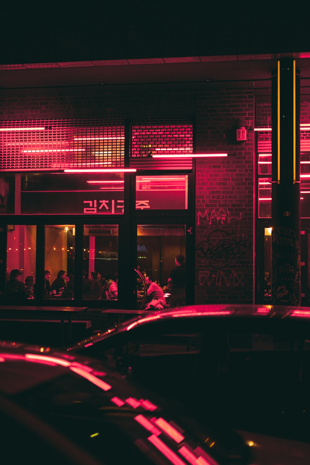 cars parked in front of store during night time