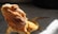 Close-up of a vibrant bearded dragon basking under a heat lamp.