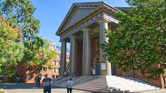 people walking on sidewalk near building during daytime
