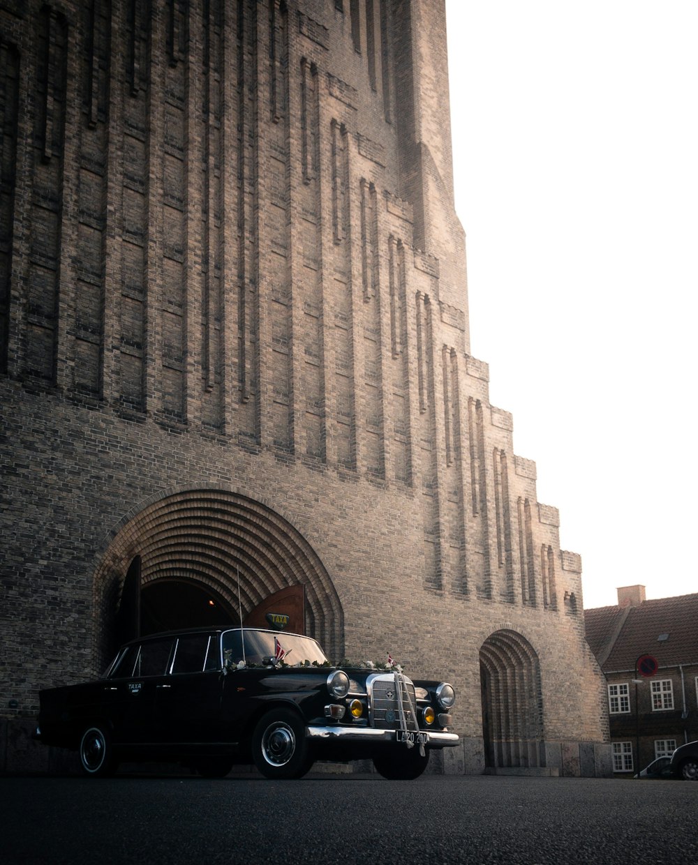 black suv parked beside brown concrete building during daytime