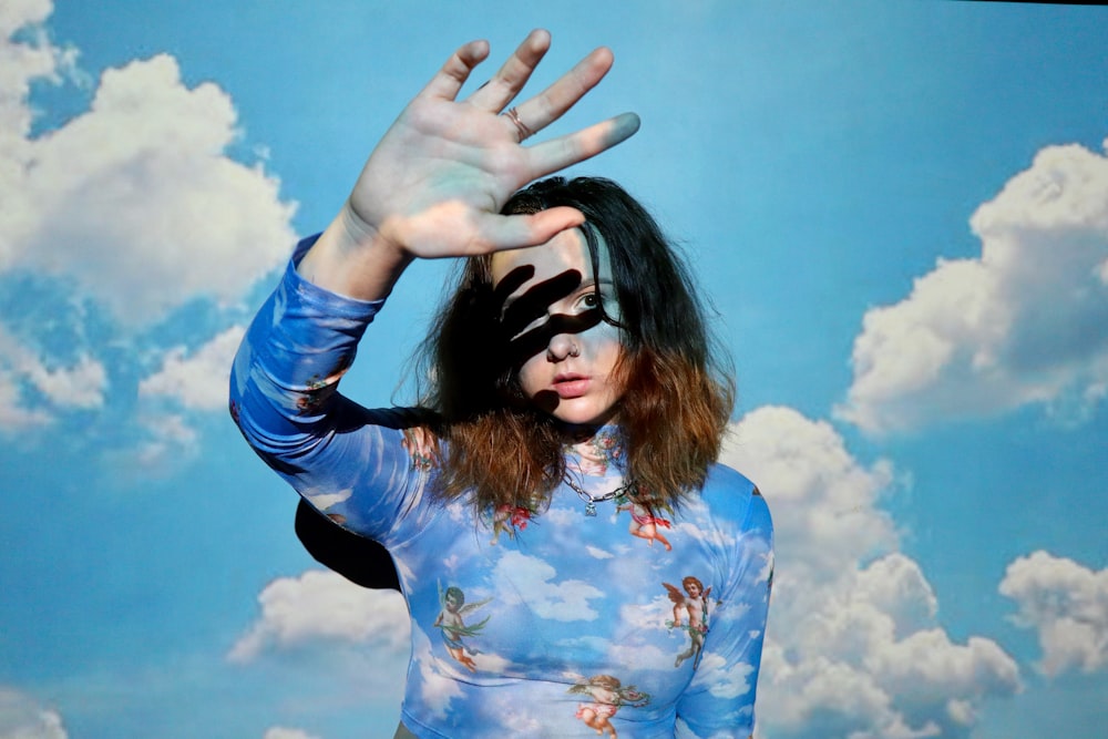 woman in blue and white floral long sleeve shirt wearing black sunglasses