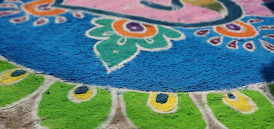 A detailed close-up of colorful rangoli patterns on the floor.