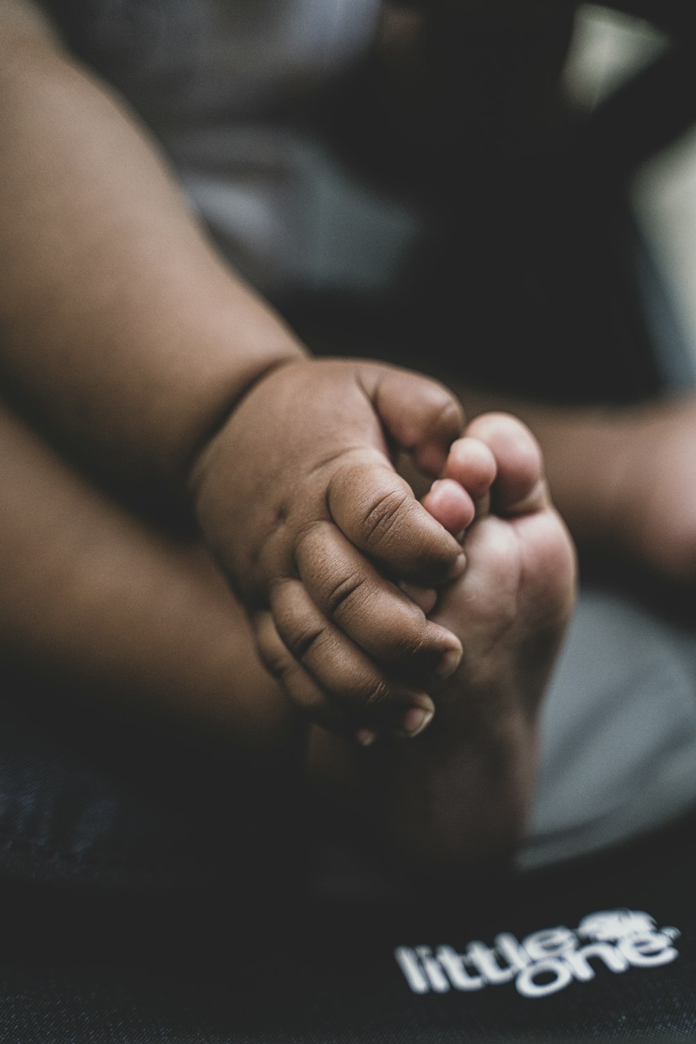 person holding babys feet