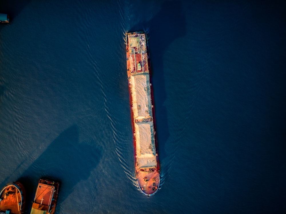 aerial view of blue and white ship on sea during daytime