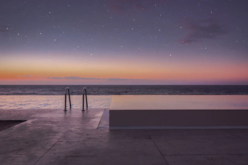 Guests enjoying the heated pool under a starry night sky.